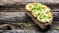 Bread with eggs salad and chives on rustic old wooden table with text space Royalty Free Stock Photo
