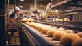 a bread factory with bread rolls on a conveyor belt, workers in blue uniforms and white hard hats, and machinery used in bread