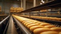 a bread factory with rows of freshly baked bread on a conveyor belt, moving through various stages of the production process under