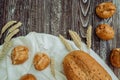 Bread with flax seeds, buns or cakes, ears of wheat on a brown wooden background, home baking 1 Royalty Free Stock Photo