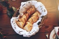 Bread, food and basket with a starter serving on a wooden dinner table in a home for a celebration event. Party, lunch Royalty Free Stock Photo