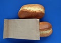 Two french rolls on a blue background