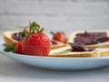 Bread, fresh strawberry, jam toasted breakfast on wooden background