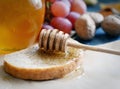 Bread with honey on paper, ripe grapes, nuts and apples on a dark background Royalty Free Stock Photo