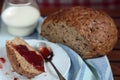 Bread with jam and glass of milk