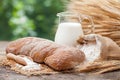 Bread, jug of milk, sack with flour and sheaf of wheat Royalty Free Stock Photo