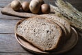 Bread loaf and wheat ears and eggs on wooden background Royalty Free Stock Photo