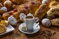 Bread with melted butter, various artisan breads and a cup of espresso on a wooden table