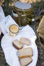 Bread, military flask, iron mug lie on a white towel
