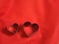 Bread molds stainless Heart shaped on fabric red background, love Valentine Day for copy text card, background Royalty Free Stock Photo