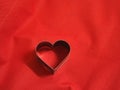 Bread molds stainless Heart shaped on fabric red background, love Valentine Day for copy text card, background Royalty Free Stock Photo