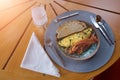 Bread, omelette and bacon in a plate with spoon knife and fork Royalty Free Stock Photo