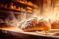 Bread in the oven at a bakery. Production and baking of fresh bread. Industrial furnace. Baking bread. Fire, smoke and steam. Royalty Free Stock Photo