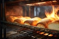 Bread in the oven at a bakery. Production and baking of fresh bread. Industrial furnace. Baking bread. Fire, smoke and steam. Royalty Free Stock Photo