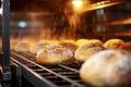 Bread in the oven at a bakery. Production and baking of fresh bread. Industrial furnace. Baking bread. Fire, smoke and steam. Royalty Free Stock Photo