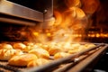 Bread in the oven at a bakery. Production and baking of fresh bread. Industrial furnace. Baking bread. Fire, smoke and steam.