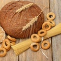 Bread, pasta and pastries on a wooden surface