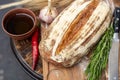 Bread, pepper, garlic, oil on a wooden table Royalty Free Stock Photo