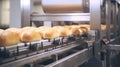 a bread production line in a factory, showing freshly baked bread rolls on a conveyor belt, with other machinery and equipment in