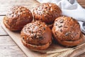 Bread products with cereals and seeds on a wooden background. Lean healthy buns, carbohydrate pastries Royalty Free Stock Photo