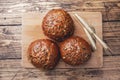 Bread products with cereals and seeds on a wooden background. Lean healthy buns, carbohydrate pastries. Copy space Royalty Free Stock Photo