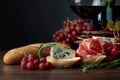 Bread with prosciutto, blue cheese and rosemary on a dark background