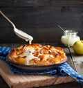 Bread pudding. Traditional English breakfast casserole with apples and vanilla sauce. Bread and butter pudding on old wooden Royalty Free Stock Photo