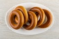 Bread rings baranka in dish on wooden table. Top view Royalty Free Stock Photo