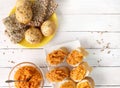 Sandwiches with pumpkin dip and bread buns with various seeds on white wooden table.