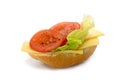 Bread roll with cheese, salad and tomatoes isolated on a white Royalty Free Stock Photo