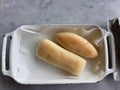 Bread rolls in white metal container