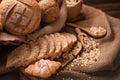 Bread and rolls in wicker basket on burlap sack Royalty Free Stock Photo