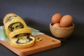 bread rolls on a wooden cutting board, a combination of several eggs in a wooden bowl Royalty Free Stock Photo