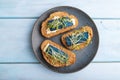 Bread sandwiches with blue lavender cheese and mustard microgreen on blue, top view, close up Royalty Free Stock Photo