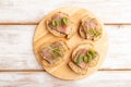 Bread sandwiches with jerky salted meat, sorrel and cilantro microgreen on white. top view