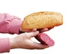 Bread and sausage in the hand of a middle-aged woman. The concept of the world food crisis associated with the war in Ukraine.