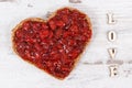 Bread in shape of heart with strawberry jam and inscription love. Rustic background Royalty Free Stock Photo