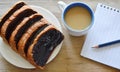 Bread slice dressing creamy chocolate sauce and coffee with book