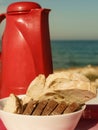 Bread slices and thermos on beach