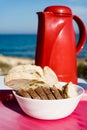 Bread slices and thermos on beach