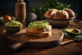 Bread spread with guacamole on a wooden board. Sandwich with mashed avocado on a dark table. Healthy vegetable food. Dieting