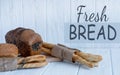 Bread and bread sticks on a light wooden background. Homemade cakes and groceries