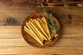 Bread Sticks on Wood Plate, Salted Breadstick, Crispy Grissini, Dry Homemade Pretzel on Wooden Background