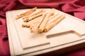 Bread sticks on wooden breadboard