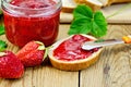 Bread with strawberry jam and a knife on board Royalty Free Stock Photo