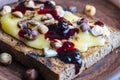 Bread toast with butter, roasted hazelnuts, honey, berry jam on plate , closeup Royalty Free Stock Photo