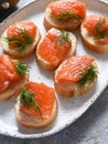 Bread toast with butter and salmon for a snack. Breakfast. Fish canapes on the table Royalty Free Stock Photo