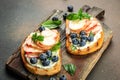 bread toast with cream cheese, honey, peaches and blueberries, Fresh healthy appetizer snack, place for text, top view Royalty Free Stock Photo