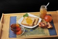 bread toast with orange marmalade. black mint tea in a transparent mug and blood oranges on a tray. Breakfast in the morning. Royalty Free Stock Photo