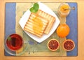 bread toast with orange marmalade. black mint tea in a transparent mug and blood oranges on a tray. Breakfast in the morning. top Royalty Free Stock Photo
